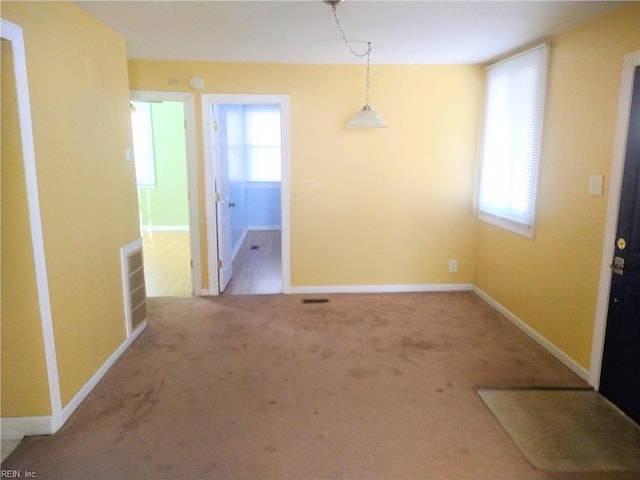 unfurnished dining area featuring carpet flooring