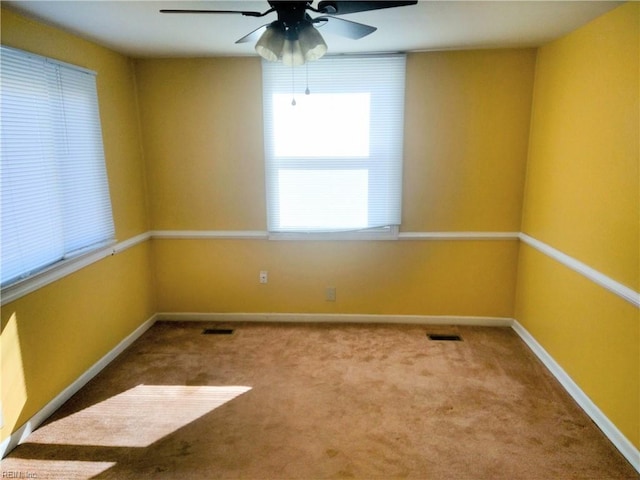 spare room with carpet floors and ceiling fan