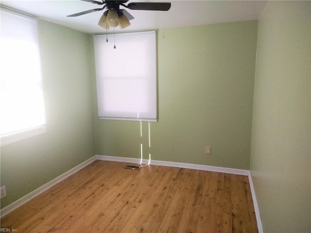 spare room featuring ceiling fan and light wood-type flooring