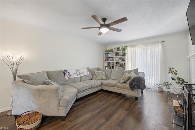 living room with ceiling fan, dark hardwood / wood-style floors, crown molding, and a textured ceiling