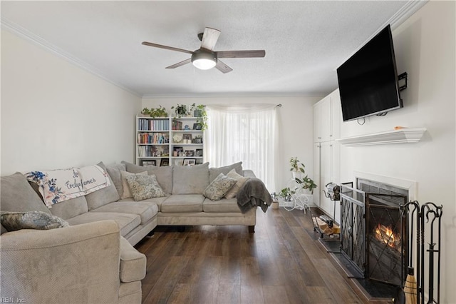 living room with ceiling fan, dark hardwood / wood-style floors, and crown molding