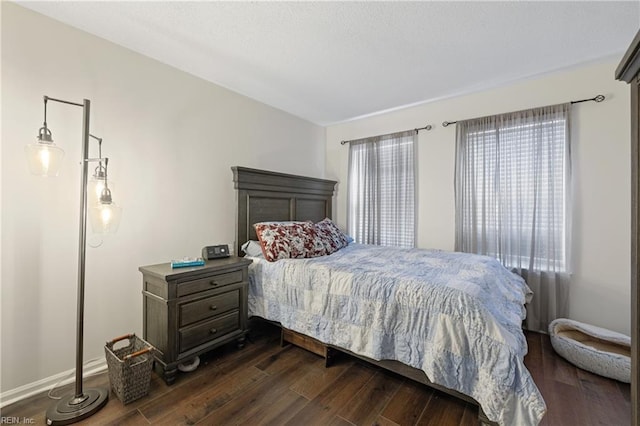 bedroom with dark hardwood / wood-style floors