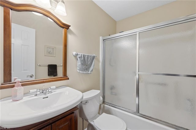 full bathroom with toilet, sink, and shower / bath combination with glass door