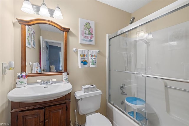 full bathroom featuring toilet, vanity, and shower / bath combination with glass door