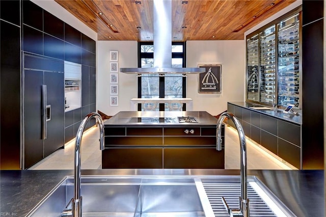 kitchen featuring stainless steel counters, paneled built in refrigerator, and wood ceiling