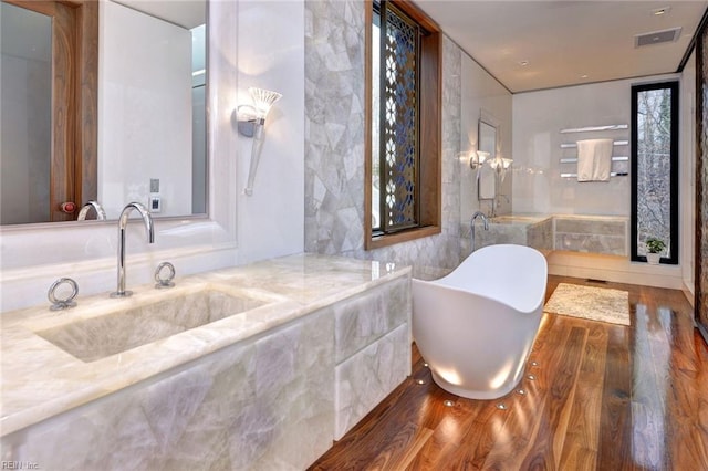 bathroom with vanity and hardwood / wood-style flooring