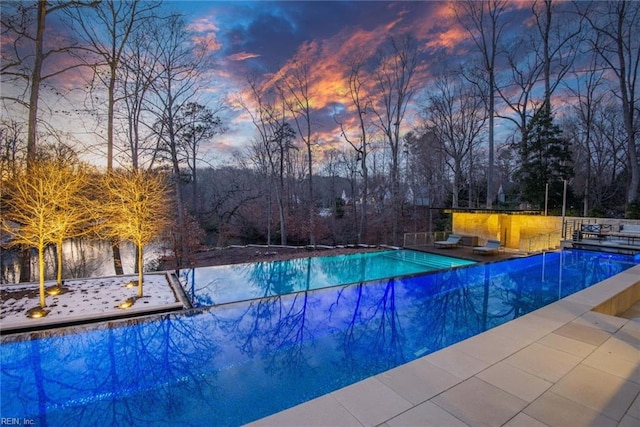 view of pool at dusk