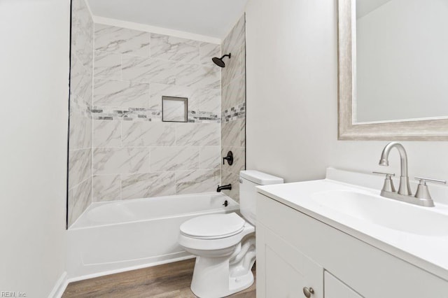 full bathroom featuring toilet, vanity, tiled shower / bath combo, and hardwood / wood-style flooring