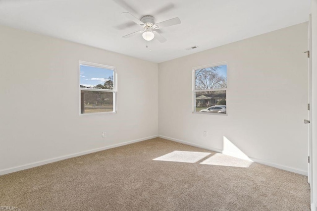 carpeted empty room featuring ceiling fan