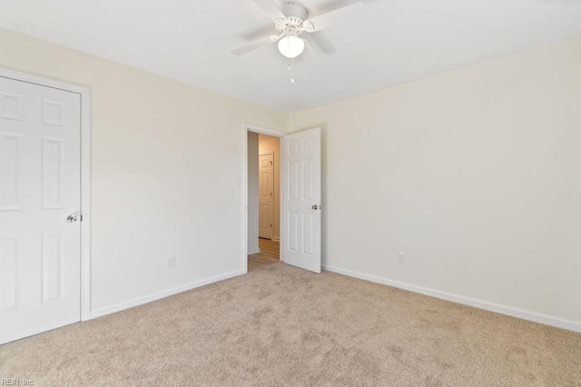 unfurnished bedroom featuring ceiling fan and light colored carpet