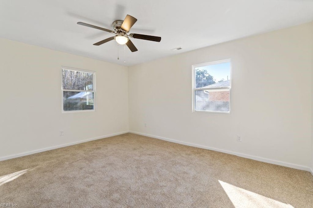 spare room featuring carpet flooring and ceiling fan