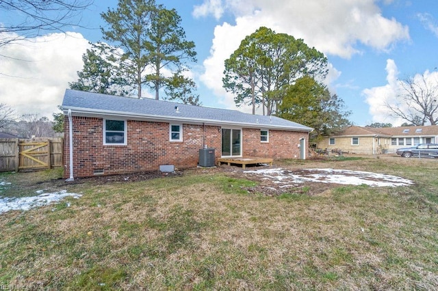 rear view of property with a yard and cooling unit