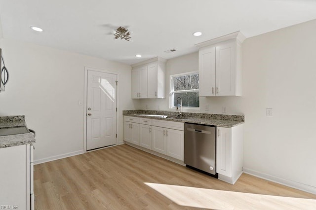 kitchen with sink, white cabinetry, light wood-type flooring, light stone countertops, and appliances with stainless steel finishes