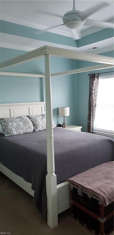 bedroom with dark colored carpet