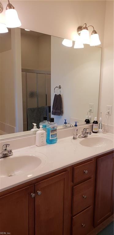 bathroom featuring an enclosed shower and vanity