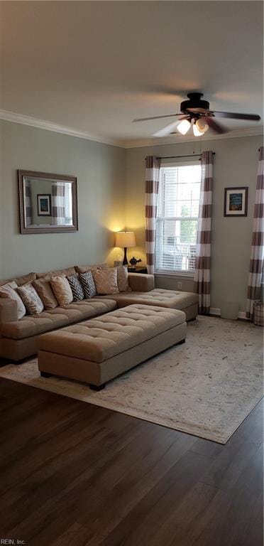 living room featuring wood-type flooring, ceiling fan, and crown molding