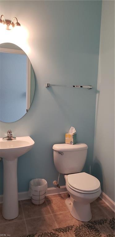 bathroom with toilet and tile patterned floors