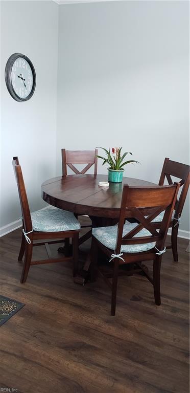 dining area featuring dark wood-type flooring