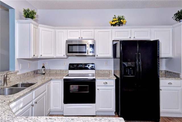 kitchen featuring white cabinets, black fridge with ice dispenser, sink, and electric range oven