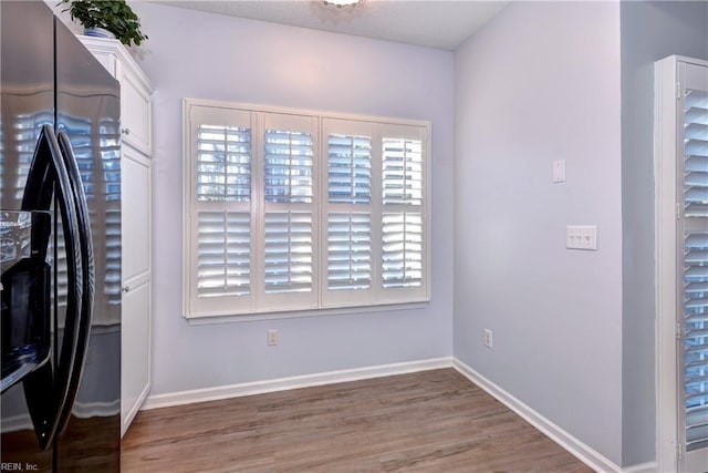 interior space featuring dark hardwood / wood-style flooring, washing machine and clothes dryer, and cabinets