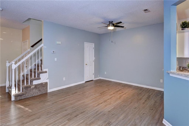 unfurnished living room featuring ceiling fan, a textured ceiling, and hardwood / wood-style flooring