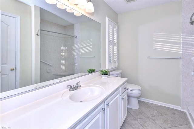 bathroom featuring walk in shower, vanity, tile patterned floors, and toilet