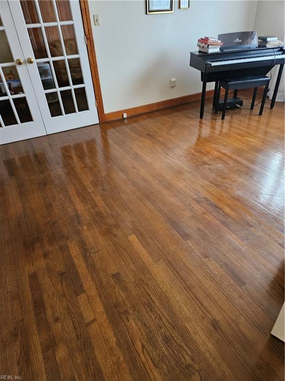 miscellaneous room featuring hardwood / wood-style flooring and french doors