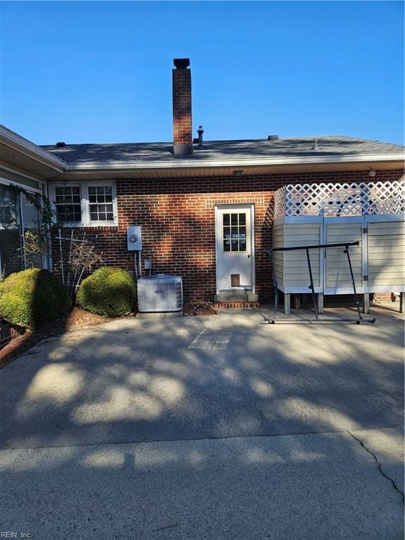 rear view of house featuring a patio and cooling unit