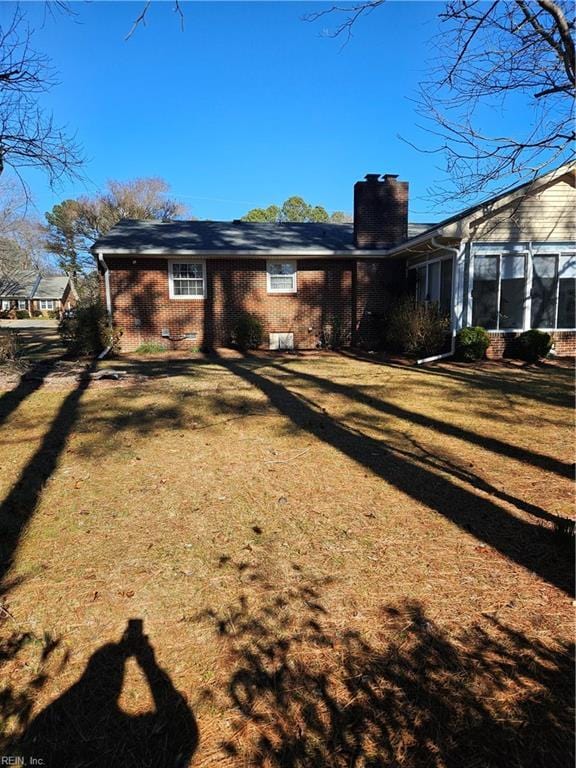 rear view of property featuring a yard