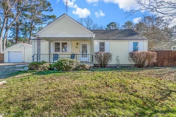 view of front of property with a garage, an outdoor structure, a front lawn, and a porch