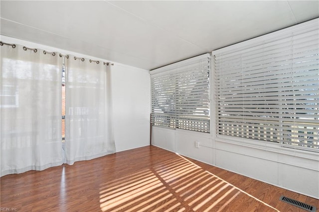 unfurnished room with hardwood / wood-style flooring