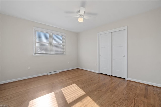 unfurnished bedroom featuring ceiling fan, a closet, and light hardwood / wood-style floors