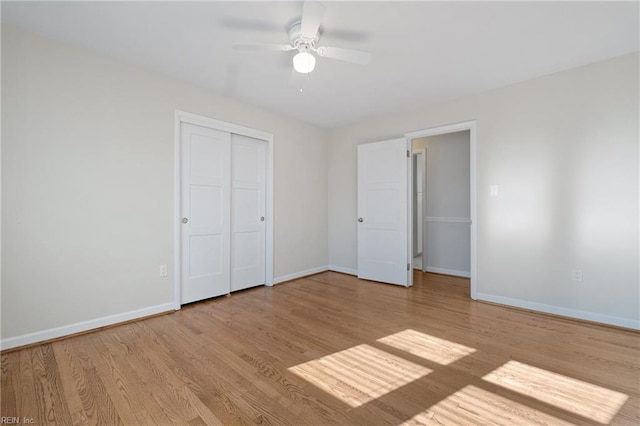 unfurnished bedroom with ceiling fan, a closet, and light hardwood / wood-style floors