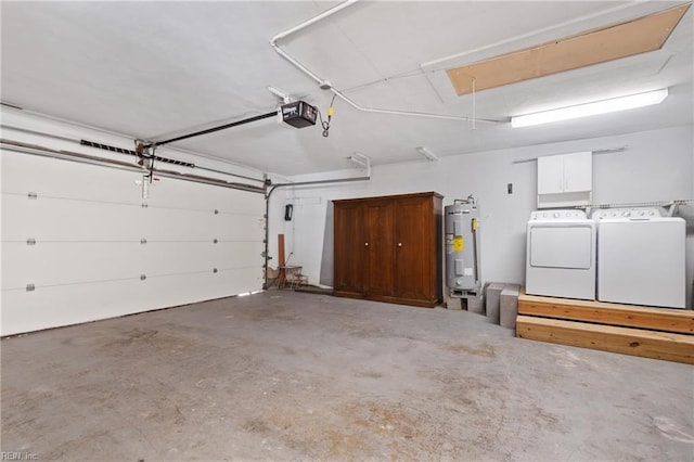 garage featuring a garage door opener, washing machine and clothes dryer, and electric water heater