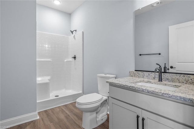 bathroom with vanity, toilet, a shower, and hardwood / wood-style flooring