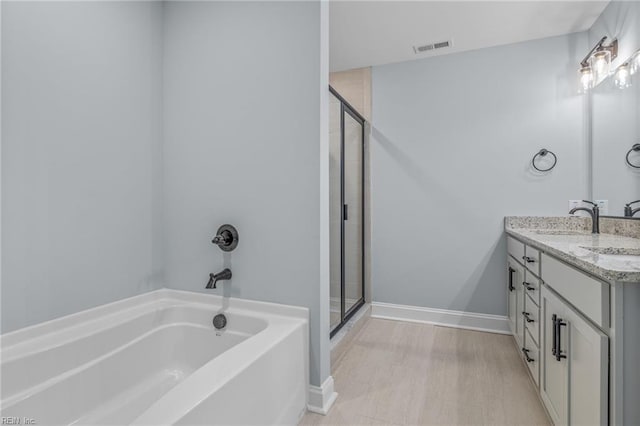 bathroom featuring vanity and plus walk in shower