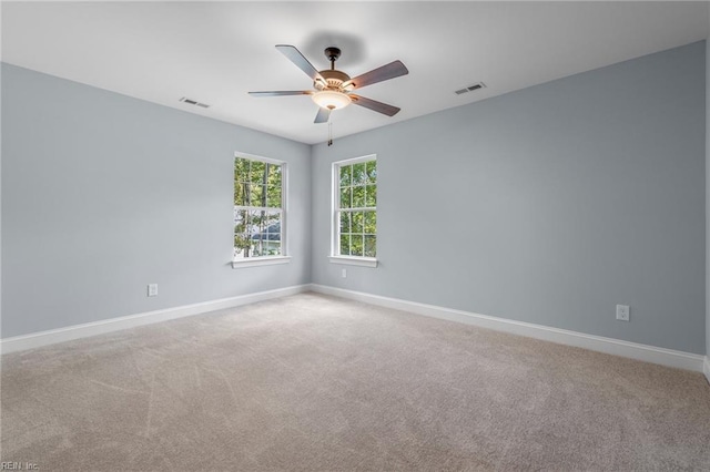 carpeted spare room with ceiling fan