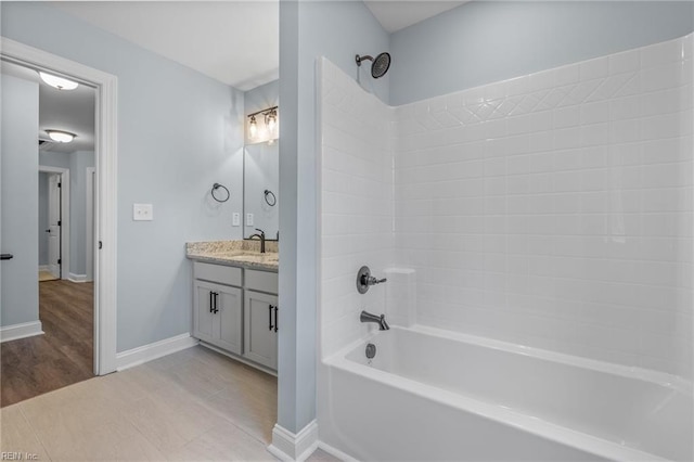 bathroom featuring shower / washtub combination, tile patterned flooring, and vanity