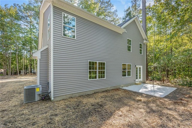 rear view of property with a patio and cooling unit