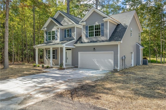 view of front of house with a garage, a porch, and central AC unit