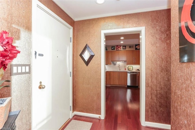 corridor featuring sink and hardwood / wood-style floors