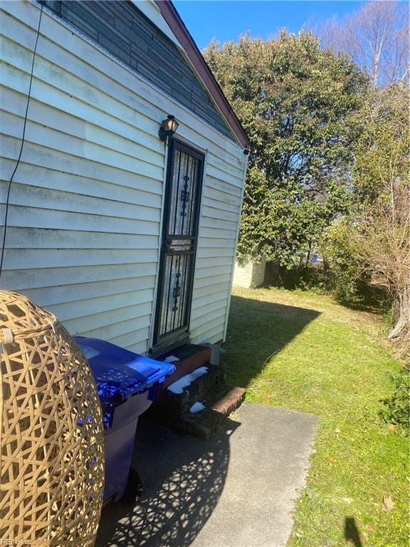 doorway to property featuring a yard