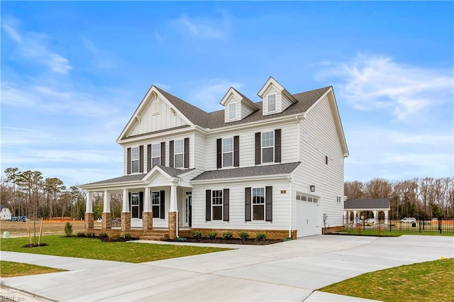 view of front of home featuring a front yard, a garage, and a porch