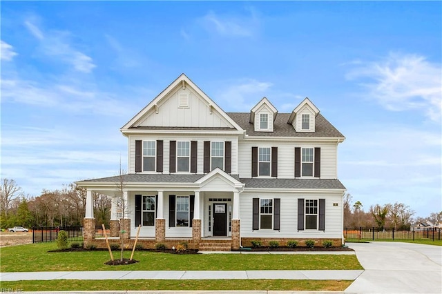 view of front of house featuring a front lawn and covered porch