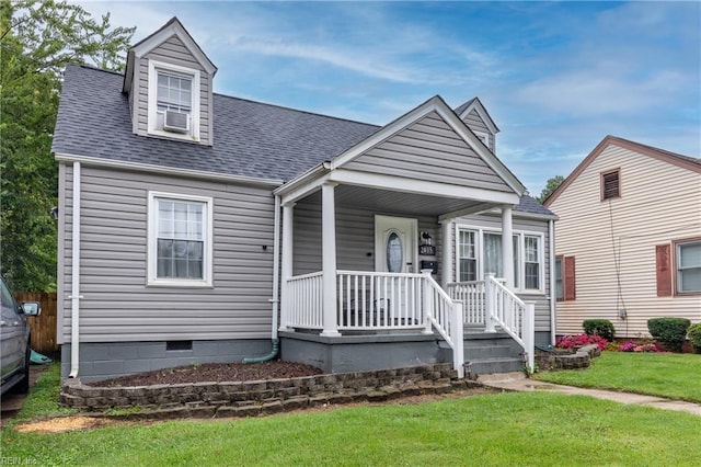 view of front of house with a porch, cooling unit, and a front yard