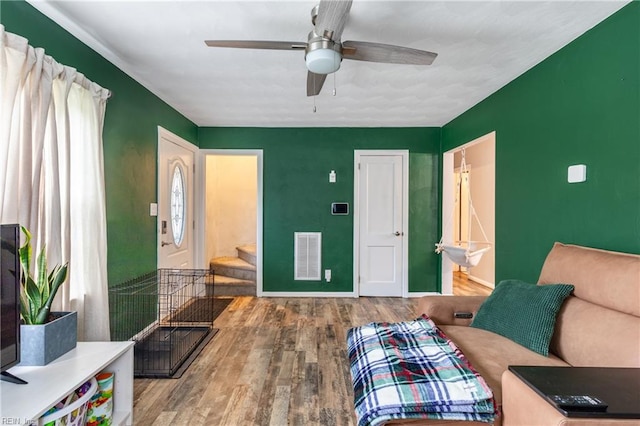 living area featuring ceiling fan and hardwood / wood-style flooring