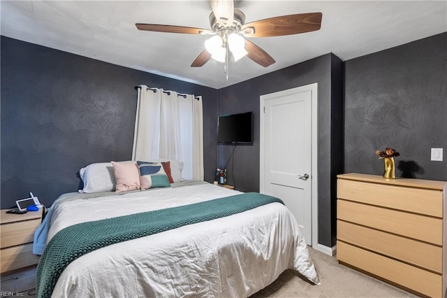 bedroom with ceiling fan and light colored carpet