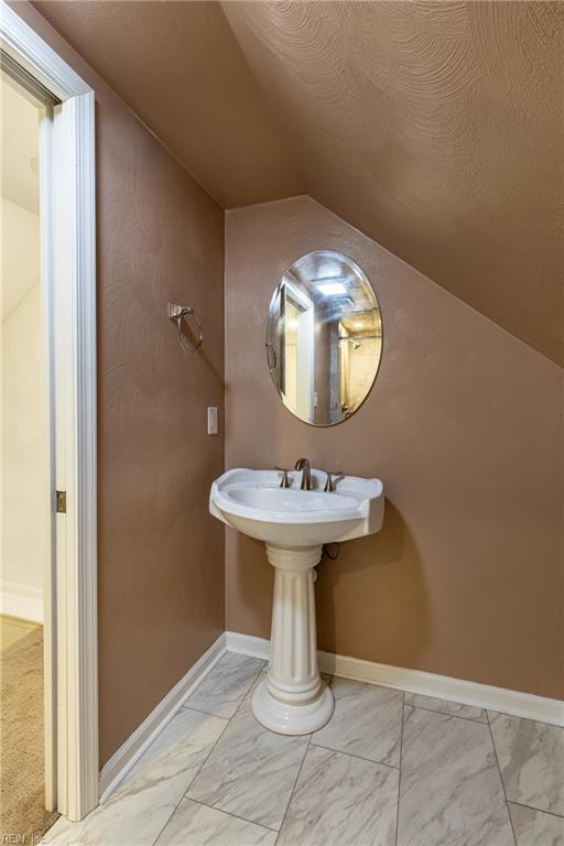 bathroom with lofted ceiling