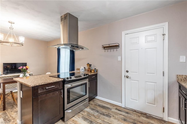 kitchen with island range hood, kitchen peninsula, a notable chandelier, stainless steel range with electric stovetop, and dark brown cabinetry