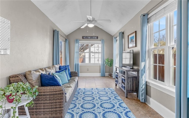 tiled living room with ceiling fan and lofted ceiling